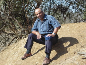 Abdel Fattah is sitting on a termite mound in a forest lying in Ad Damazin, the capital of Blue Nile State in Sudan. (Photograph by Dr. Sakina Yagi)